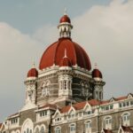 Stunning view of the Taj Mahal Palace Hotel's red domes in Mumbai, India.