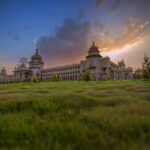 Capture of Vidhana Soudha in Bengaluru with a vibrant sunset sky, showcasing beautiful architecture.